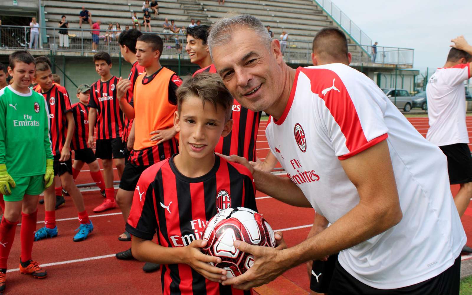 Coach Diego Bortoluzzi assigns the ball to a boy of the AC Milan Academy Junior Camp