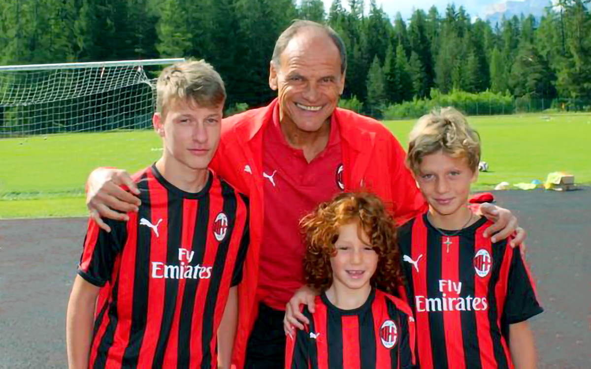 Walter De Vecchi, former AC Milan player and coach, with three children of the AC Milan Academy Camp