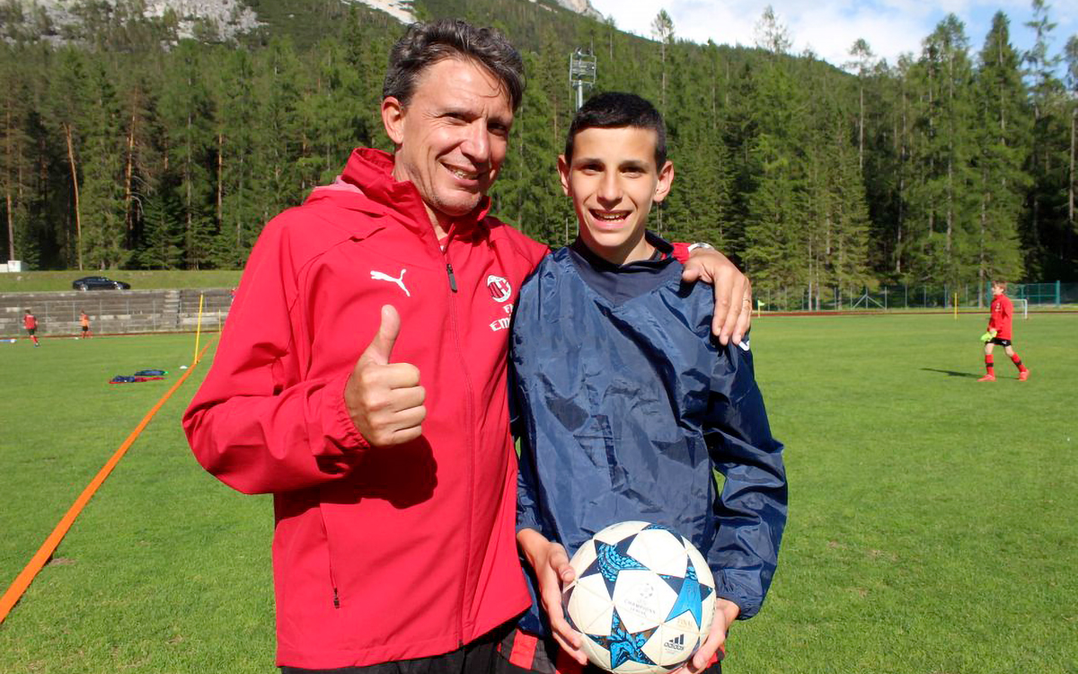 Stefano Eranio, ex AC Milan footballer and coach, with a boy of the AC Milan Academy Camp