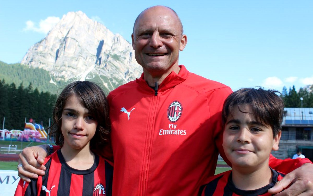 Pietro Vierchowod, former AC Milan player and coach, with two children of the AC Milan Academy Camp
