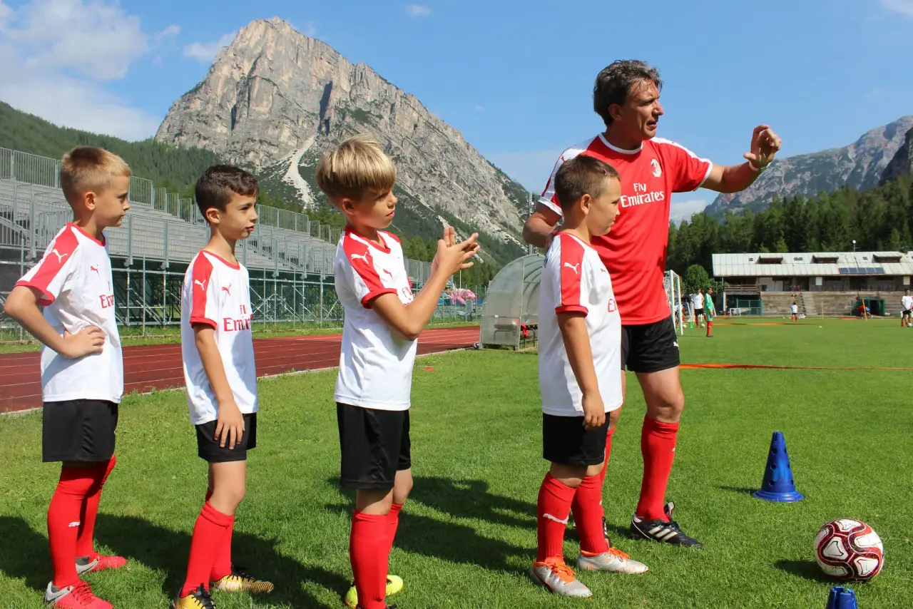 AC Milan coach follows boys and girl during the training in the AC Milan Camp on Demand