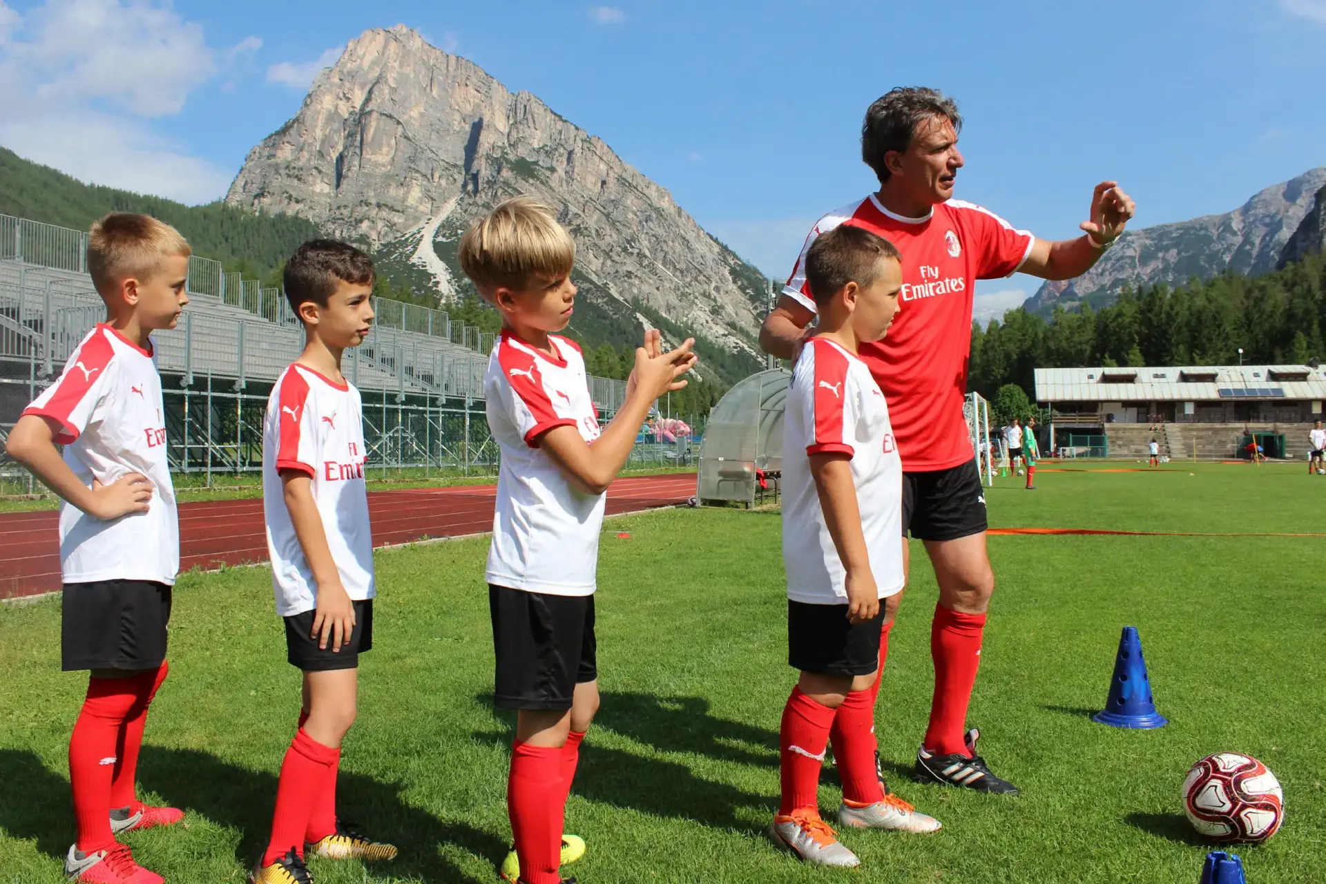 AC Milan coach follows boys and girl during the training in the AC Milan Camp on Demand